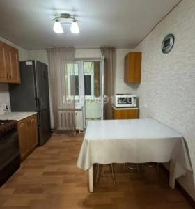 a kitchen with a table with a white table cloth on it at Уютный уголок in Aktobe