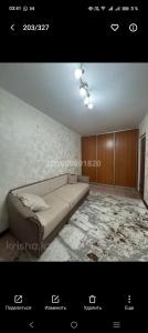a living room with a couch in a room at Уютный уголок in Aktobe