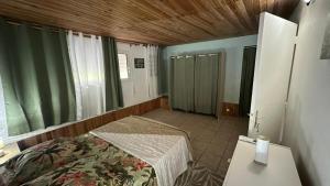 a bedroom with a bed and a table in a room at La Maison Du Bonheur in Capesterre-Belle-Eau