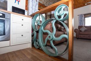 a living room with an octopus art on the wall at Treetop View - Old Mill Cottages in Ilfracombe