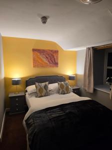 a bedroom with a large bed with two night stands at The Elks Head Inn in Whitfield