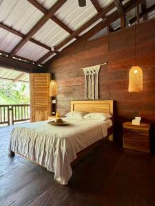 a bedroom with a large bed with wooden walls at Mareselva Lodge in Acanti