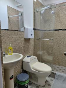 a bathroom with a toilet and a sink and a shower at Casa Puka in Puerto Baquerizo Moreno +45 photos