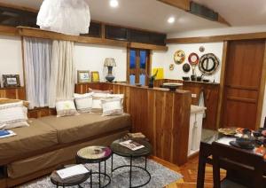 a room with a bed and two tables in it at Rimbud guest house in Hārer