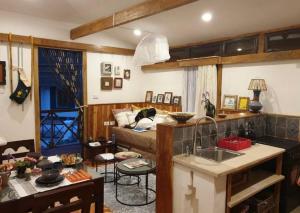 a kitchen and a living room with a couch at Rimbud guest house in Hārer