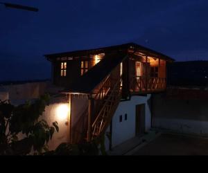 a house with a staircase on the side of it at night at Rimbud guest house in Hārer