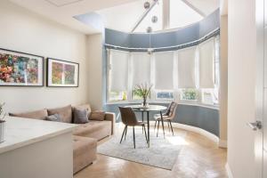 a living room with a couch and a table at London Studios and Suites in Harrow