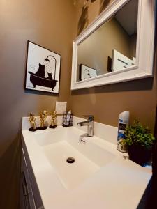 a bathroom with a white sink and a mirror at Master Suite De Carlo Shared Property PRIVATE stay NYC 18mins in North Bergen +18 photos