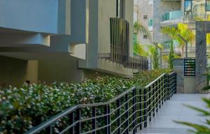 a stairway next to a building with bushes and flowers at SA Apartments! Luxury Residence with Private Beach in Alanya