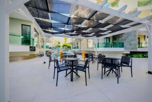a patio with tables and chairs in a building at SA Apartments! Luxury Residence with Private Beach in Alanya +70 photos