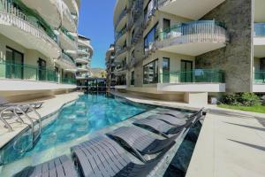 a swimming pool in the middle of a building at SA Apartments! Luxury Residence with Private Beach in Alanya
