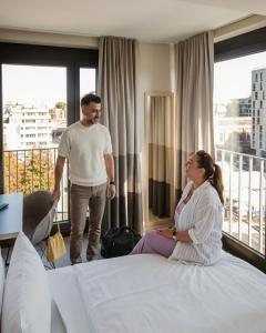 a man and a woman standing in a hotel room at Schulz Hotel Berlin Wall at the East Side Gallery in Berlin