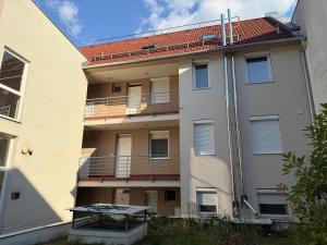 an external view of a building with a balcony at LOTZ Apartman in Pécs