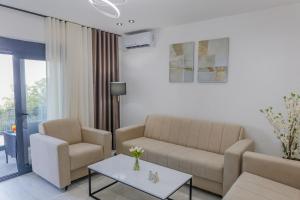 a living room with a couch and two chairs and a table at Villa MONTE Ulcinj in Stegvaši