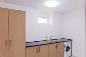 a kitchen with a sink and a washing machine at Villa MONTE Ulcinj in Stegvaši +32 photos