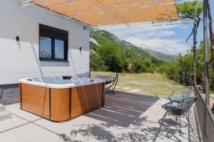 a hot tub on a patio with a view at Villa MONTE Ulcinj in Stegvaši