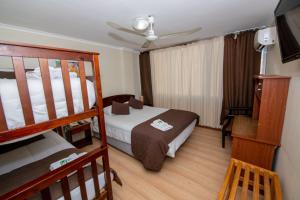 a bedroom with a bed and a bunk bed at Hotel San Francisco De la Selva in Copiapó