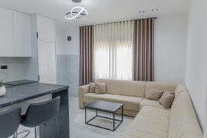 a living room with a couch and a table at Villa MONTE Ulcinj in Stegvaši