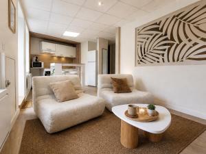 a living room with a couch and a coffee table at La Maison De Colette in Lezoux