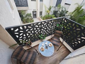 a balcony with a table and chairs on a balcony at Palm Paradise in Sukrah