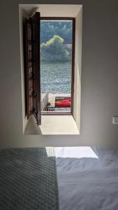 a room with a window looking out at the water at Casa rural A Fonte, Balneario Histórico de Cortegada in Cortegada