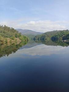 an aerial view of a large lake with trees at Casa rural A Fonte, Balneario Histórico de Cortegada in Cortegada