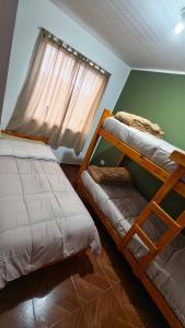two bunk beds in a room with a window at Los 3 Gurises in Gualeguay +7 photos