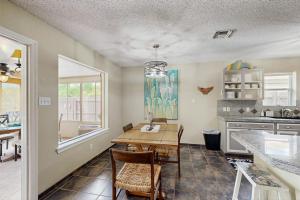 a kitchen with a table and a dining room at Golden Palms in Laguna Vista