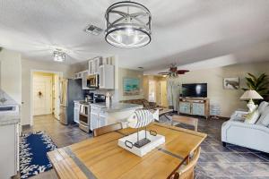 a living room with a dining table and a kitchen at Golden Palms in Laguna Vista