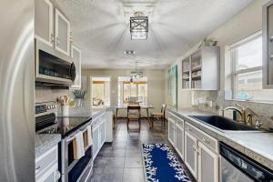 a large kitchen with white cabinets and a table at Golden Palms in Laguna Vista +12 photos