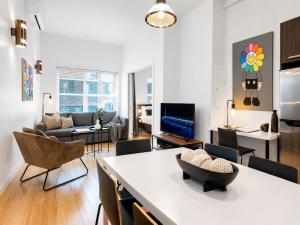 a living room with a couch and a table at LiV MTL Main Plateau Suites Near Downtown Montreal in Montreal