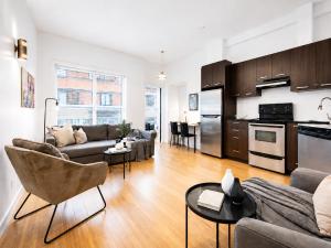 a living room with a couch and a table at LiV MTL Main Plateau Suites Near Downtown Montreal in Montreal