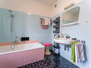 a bathroom with a tub and a sink at Nussbaumer S in Niedernsill +24 photos