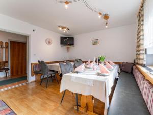 a dining room with a table and a couch at Nussbaumer in Niedernsill