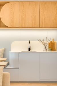 a kitchen with white cabinets and a sink at Matosinhos in Matosinhos +18 photos
