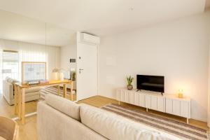 a living room with a couch and a flat screen tv at Matosinhos in Matosinhos