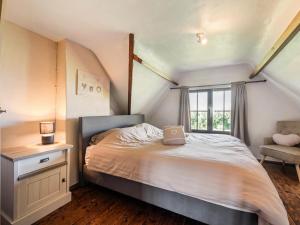 a bedroom with a bed with a laptop on it at Rozenberghoeve in Ploegsteert