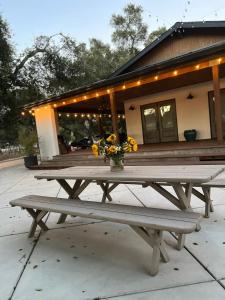 a picnic table with a vase of flowers on it at Wranglers Rest Ranch in Arroyo Grande