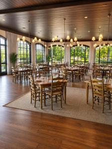a dining room with tables and chairs and windows at The Dillard House in Dillard