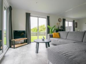 a living room with a couch and a table at De Zwaluw in Heiloo