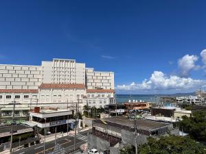 a view of a city with buildings and the ocean at Prince Plage OKINAWA 6F in Fuzuchi