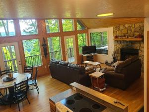 a living room with a couch and a fireplace at Further Up & Further In in Topton