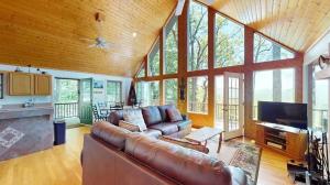 a large living room with a couch and a tv at Further Up & Further In in Topton