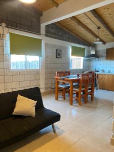 a living room with a couch and a table with chairs at Los Duraznillos in Los Antiguos
