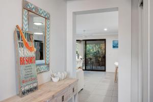 a hallway of a home with a sign in theoyer at Hideaway -4BR Family Home with Pool, Near Beach in Caloundra