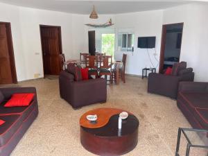a living room with two couches and a table at Villa Farou in Mbour