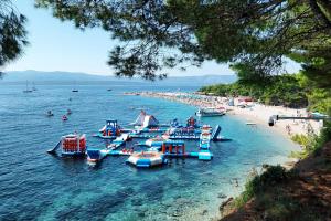 a group of boats in the water at a beach at Holiday house with a parking space Bol - Brac - 2894 in Bol