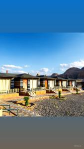 a group of buildings with mountains in the background at Victoria Luxury camp in Wadi Rum