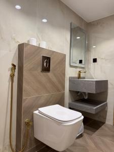 a bathroom with a white toilet and a sink at Victoria Luxury camp in Wadi Rum +52 photos