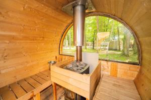 an inside view of a wooden cabin with a large window at 森と湖の楽園 ドッグラン&バレルサウナ in Fujikawaguchiko